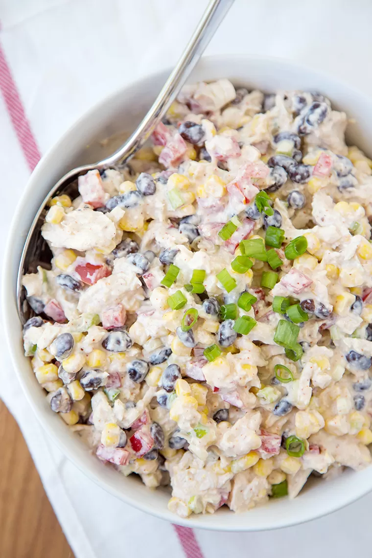 Skinny Southwest Chicken Salad in a large bowl with a spoon.