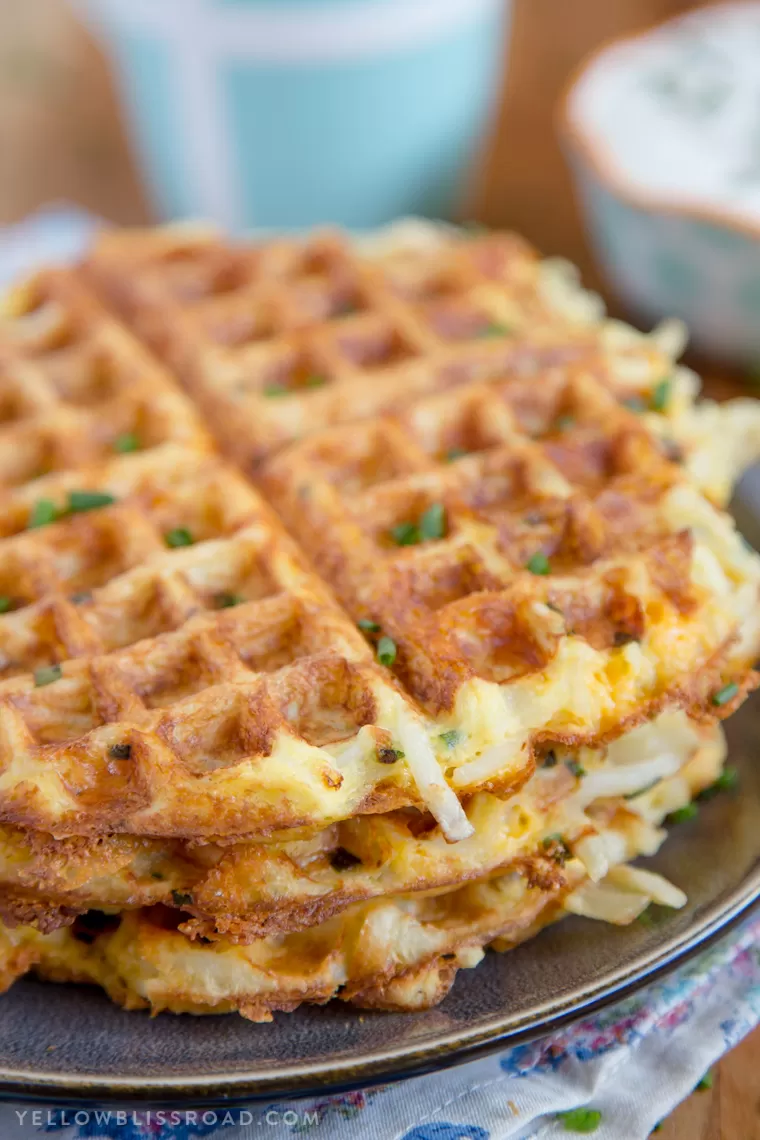 A stack of fresh, crispy Egg & Cheese Hash Brown Waffles,