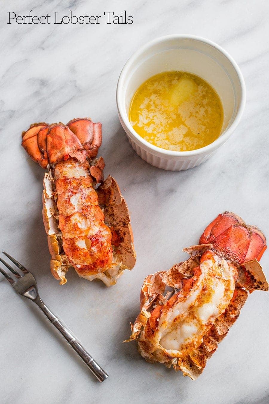Lobster tails on a table with melted butter