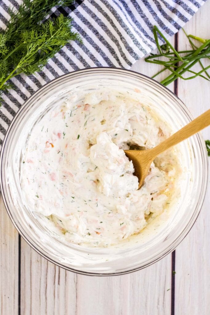 mixing bowl with smoked salmon dip and a wooden spon