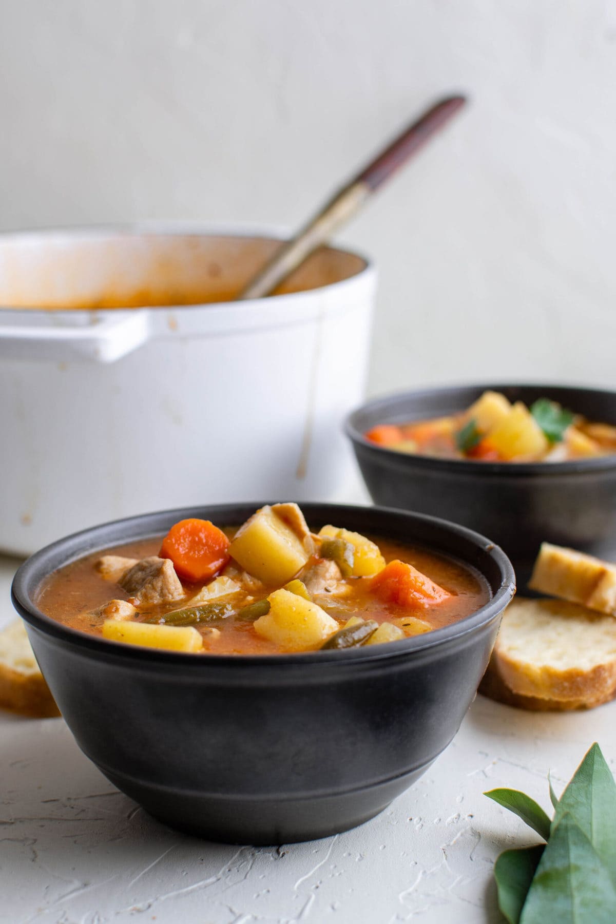 pork stew in bowls and a pot