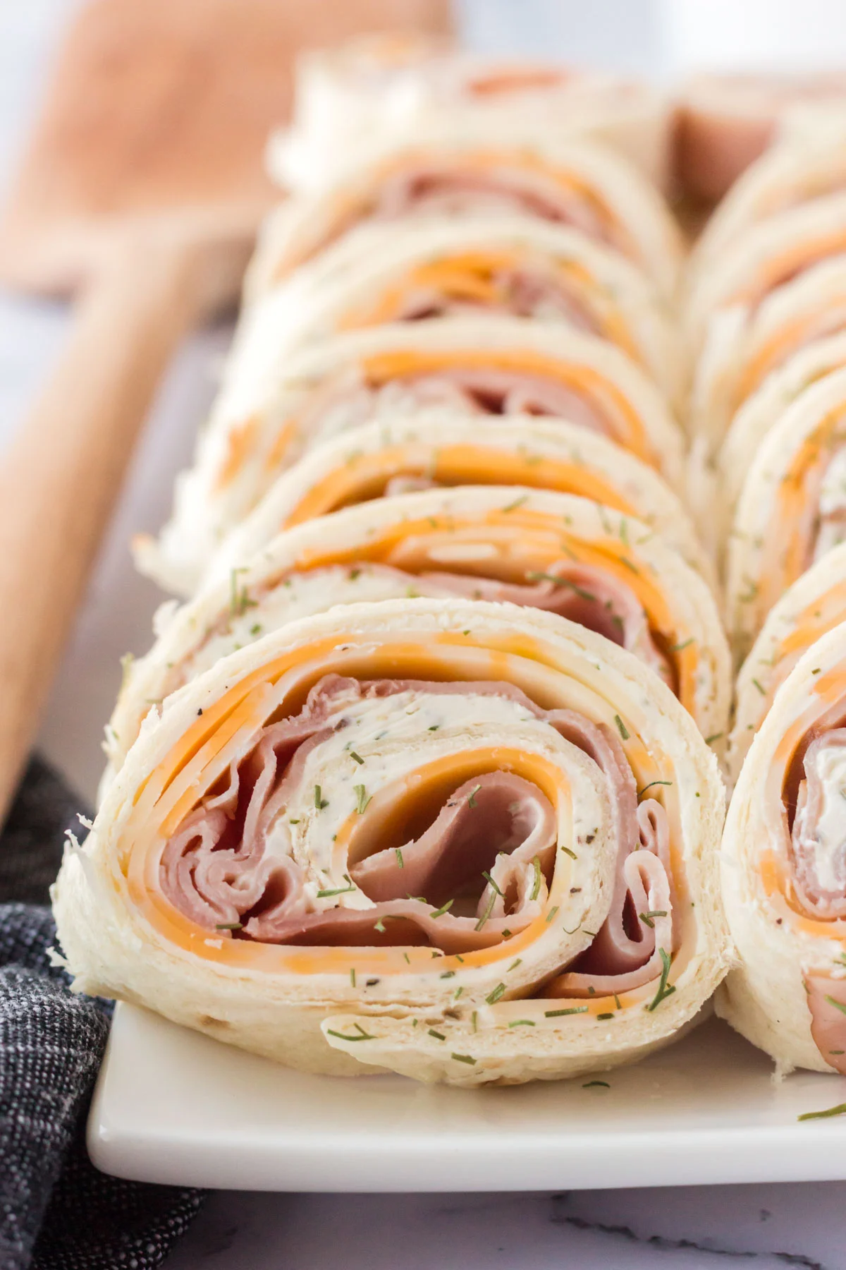 ham and cheese roll-ups on a white tray