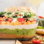 7 layer dip side view in a clear serving dish.