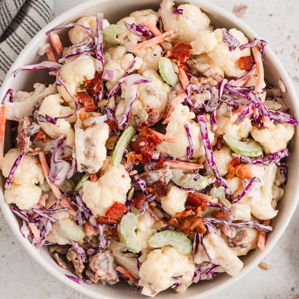 Cauliflower salad in a white bowl.