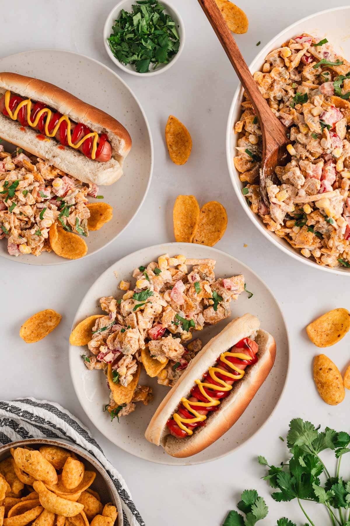 Hot dogs and frito corn salad plated.