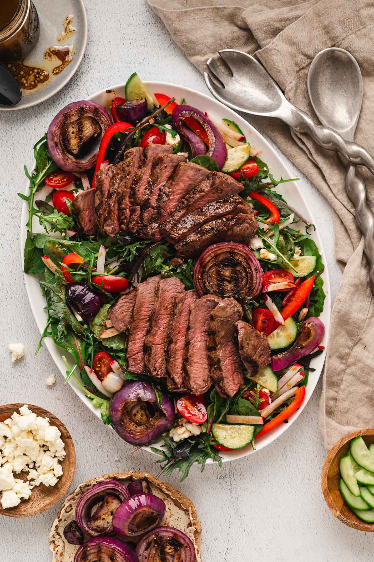 Steak salad on a white platter.