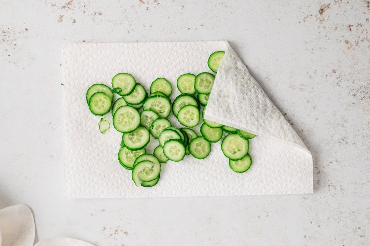 Cucumber slices on a paper towel.