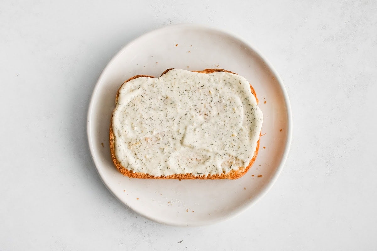 Slice of bread with mayo spread.