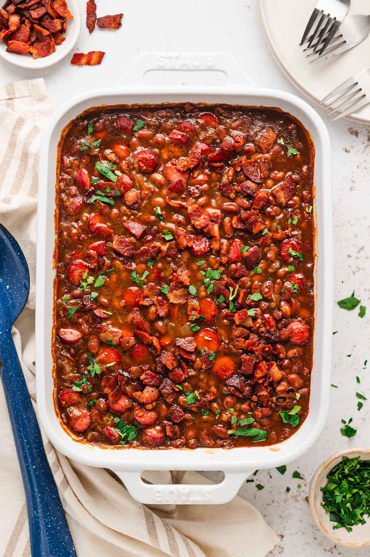 Franks and beans baked in a baking dish.