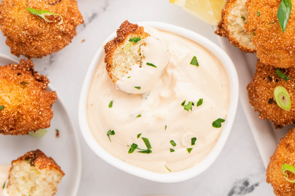 Garlic aioli dipping sauce and hush puppies. 