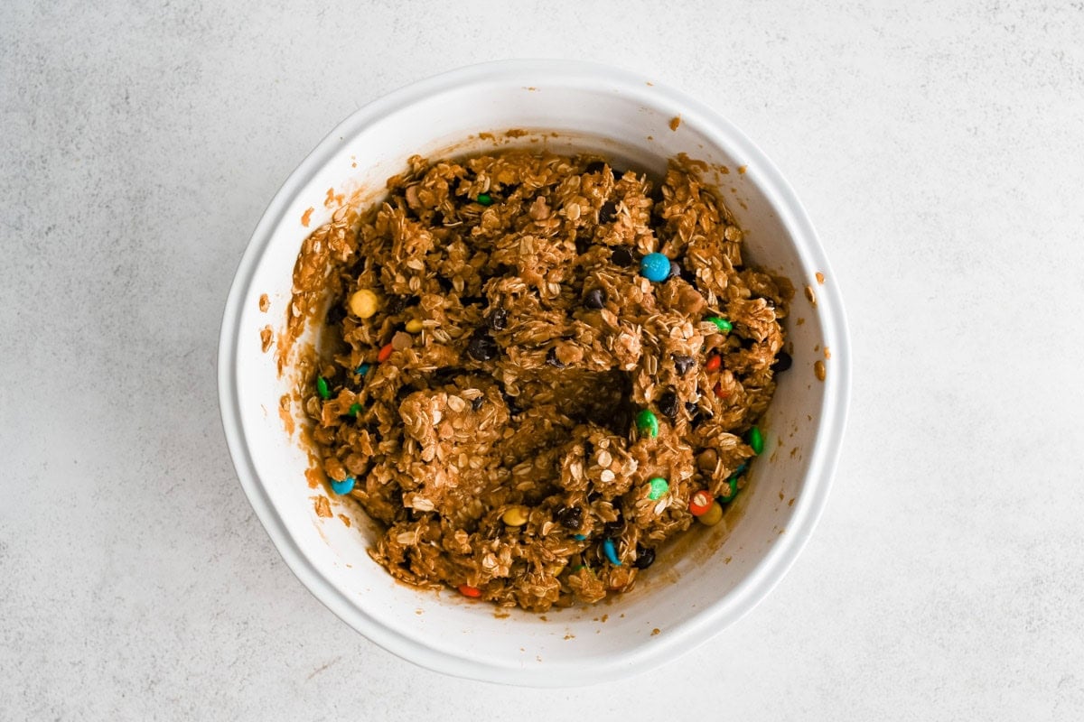 Cookie bar batter mixed with chocolate chips, m & ms and oats.
