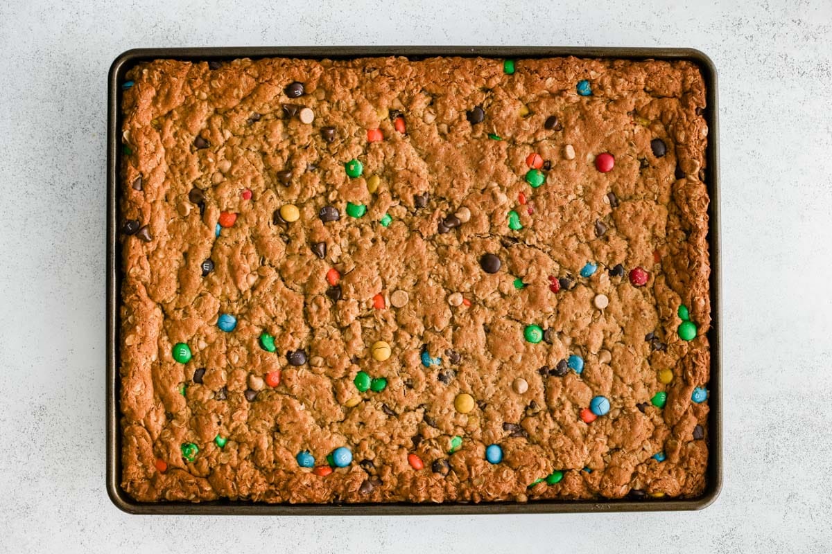 Monster cookie bars baked in a large pan.