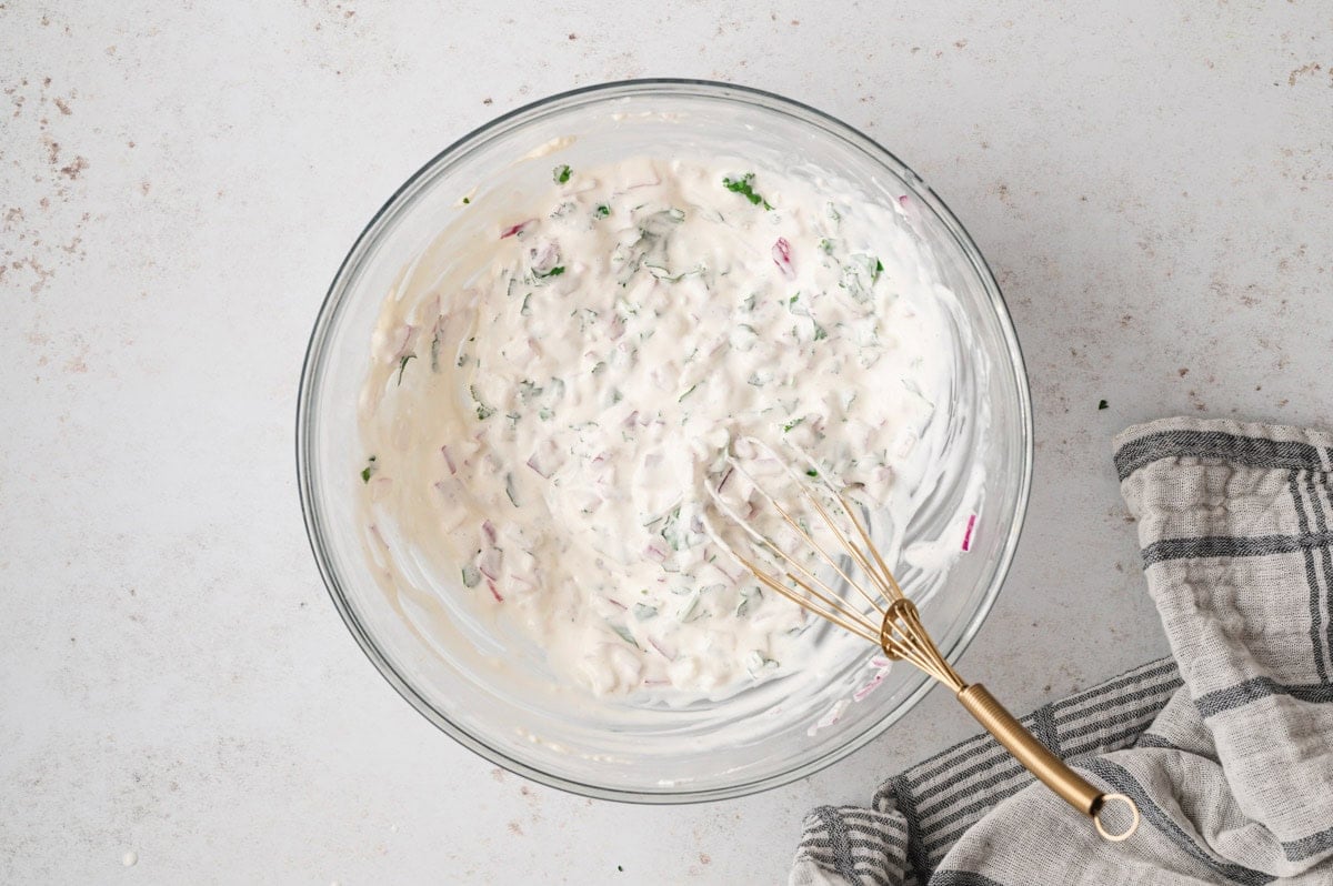Creamy mixture of sour cream and mayo in a glass bowl.