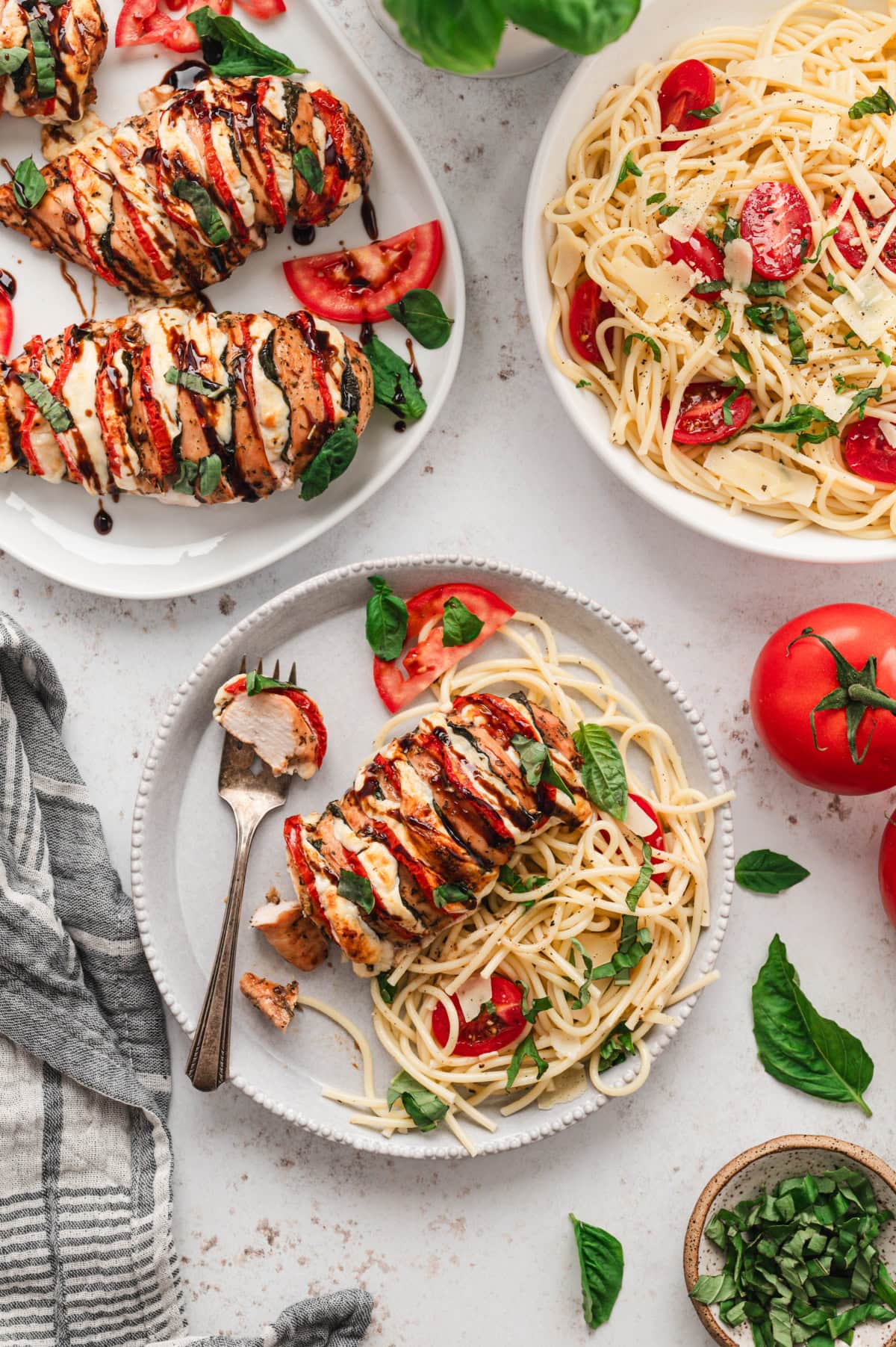 Small plates with chicken breasts stuffed with mozzarella, tomatoes and basil.