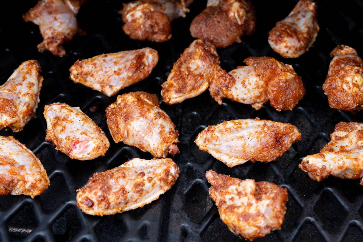 Chicken wings on a grill.