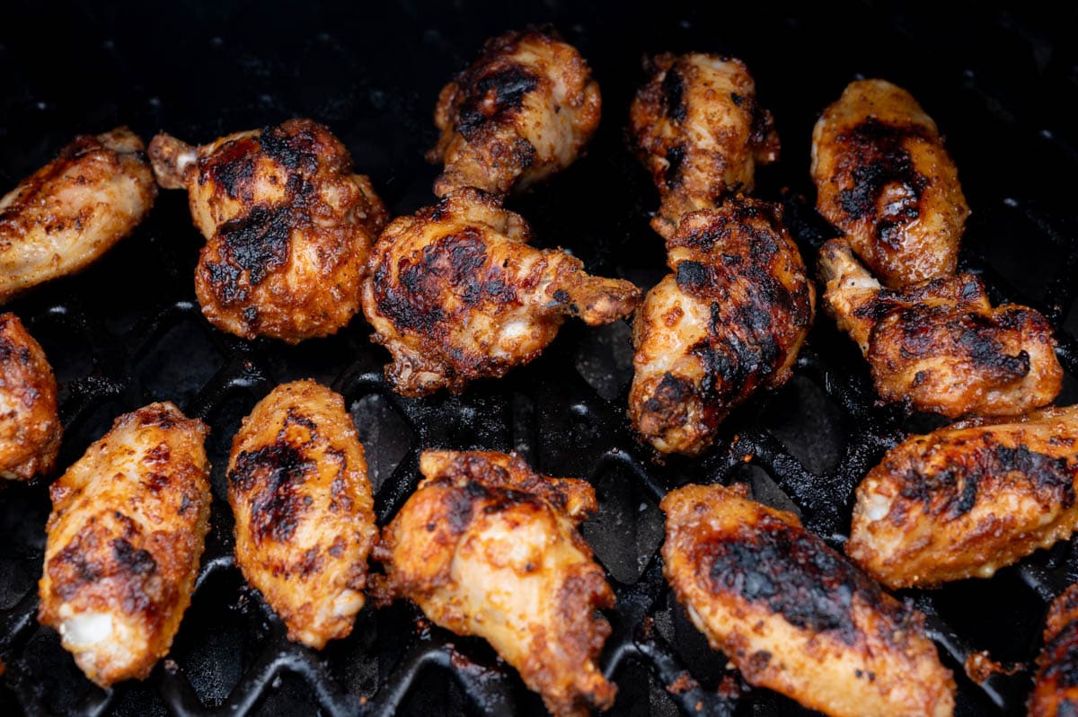 Grilling chicken wings on a grill.