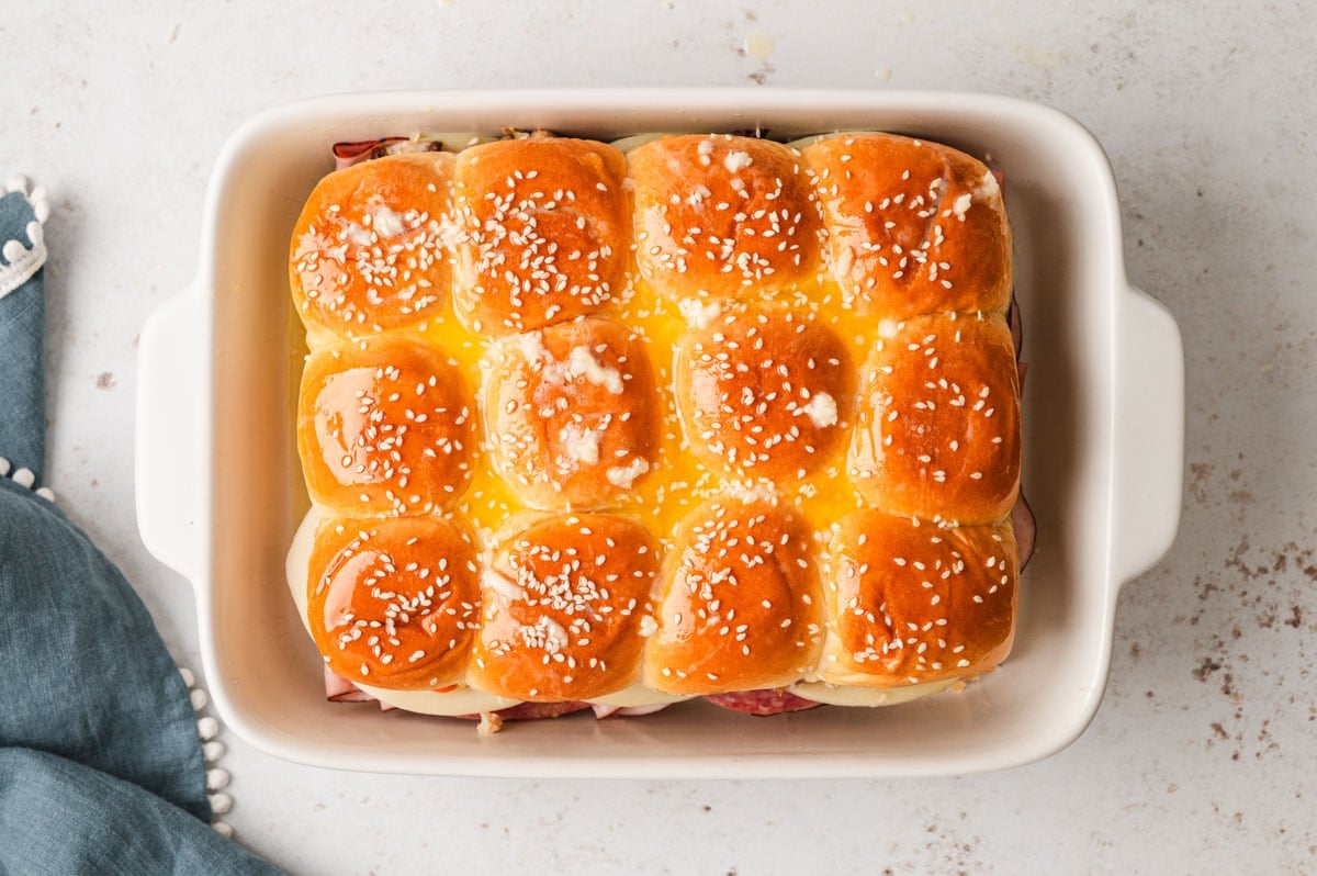 Sliders with melter butter and sesame seeds on top.