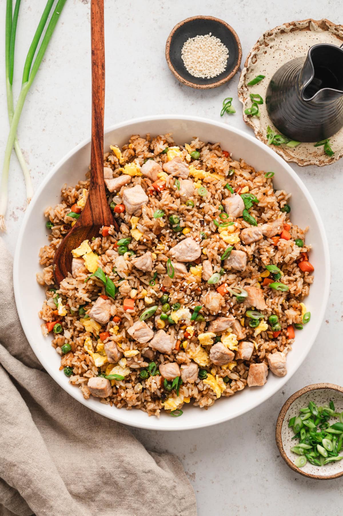 Large white serving bowl with pork fried rice.