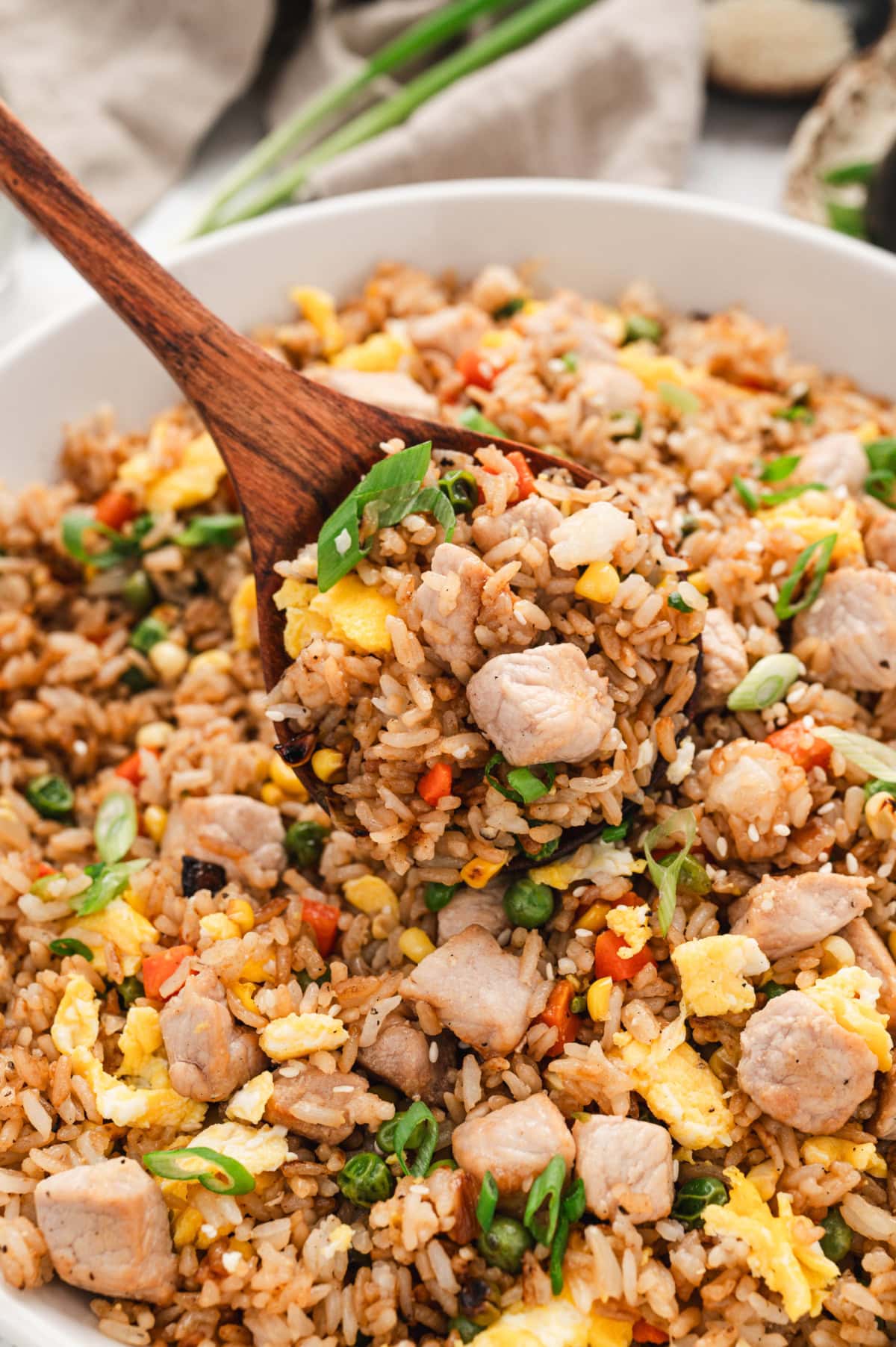 Pork fried rice with a wooden spoon.