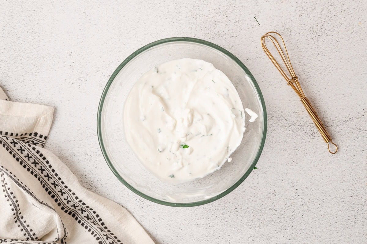 Sour cream sauce in a glass bowl.