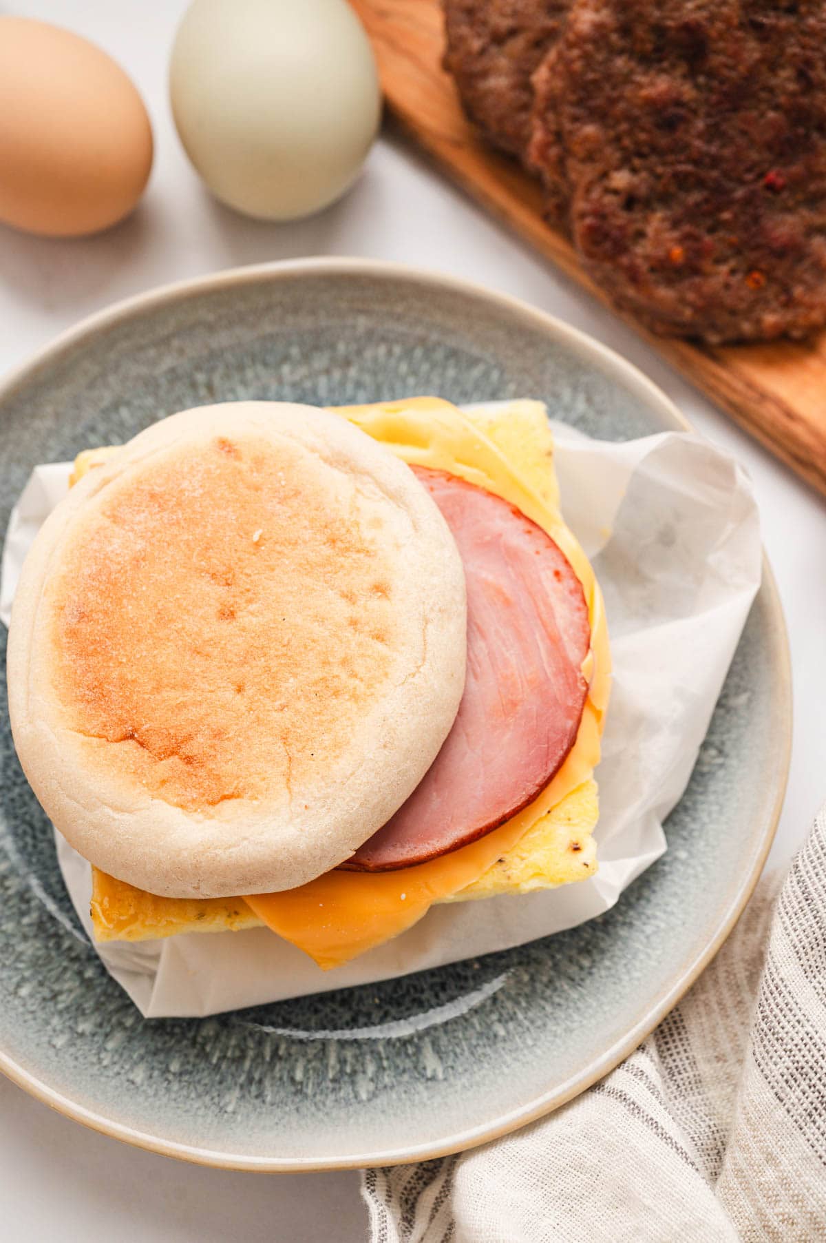 Canadian bacon topped eggs and cheese on an english muffin.