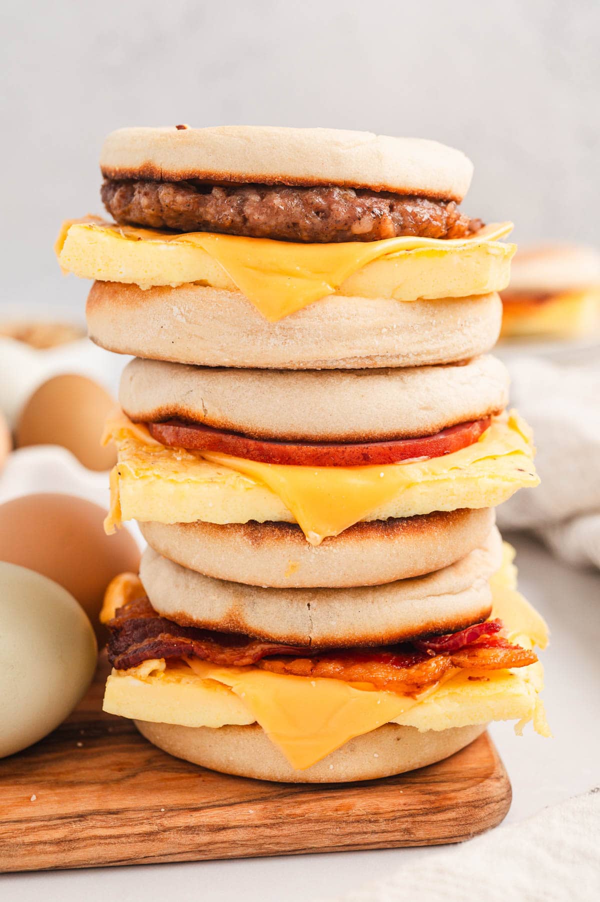 English muffin breakfast sandwiches staked by 3.