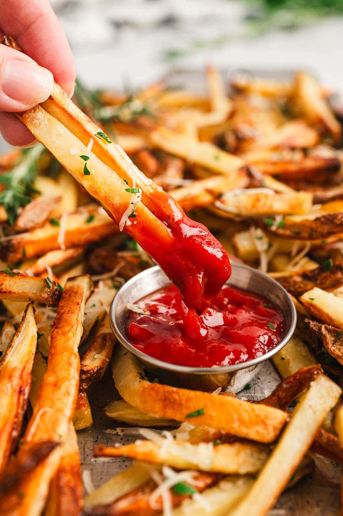 French fries dipped in ketchup.