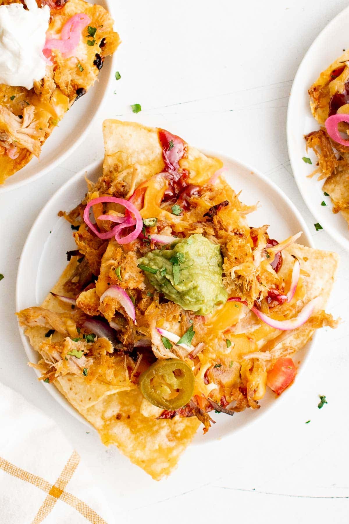 Small plate with pulled pork nachos. 