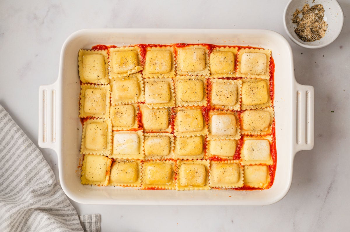 Ravioli layed out in a baking dish.