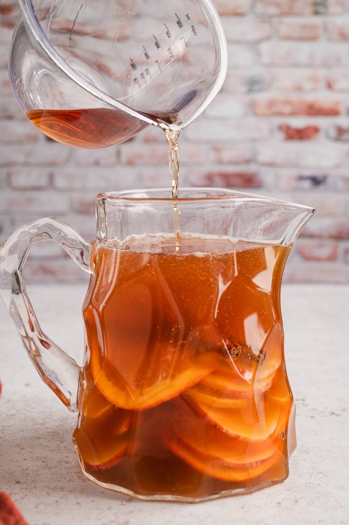 Whiskey added to pitcher of apple cider punch.