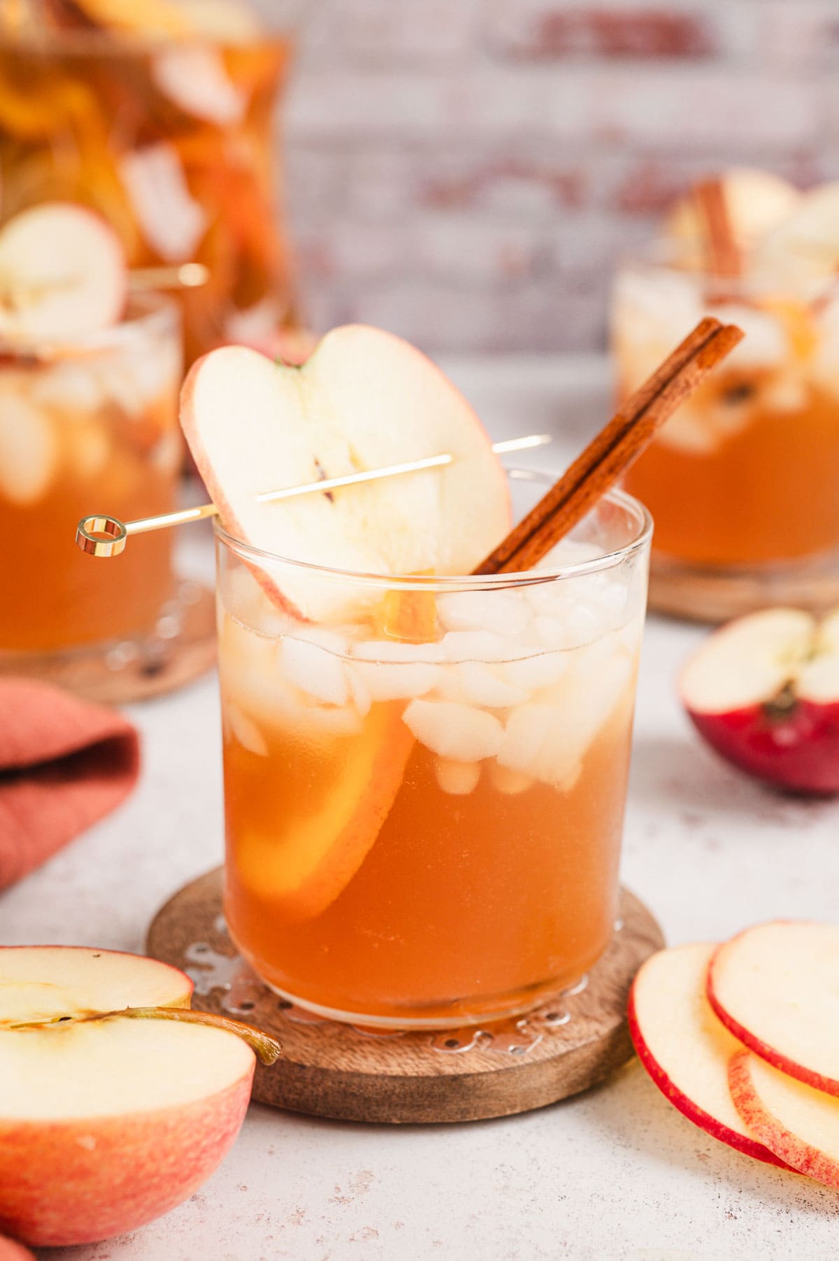 Apple cider punch in a glass with apple slice garnish.