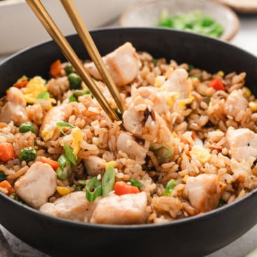 chicken fried rice in a black bowl