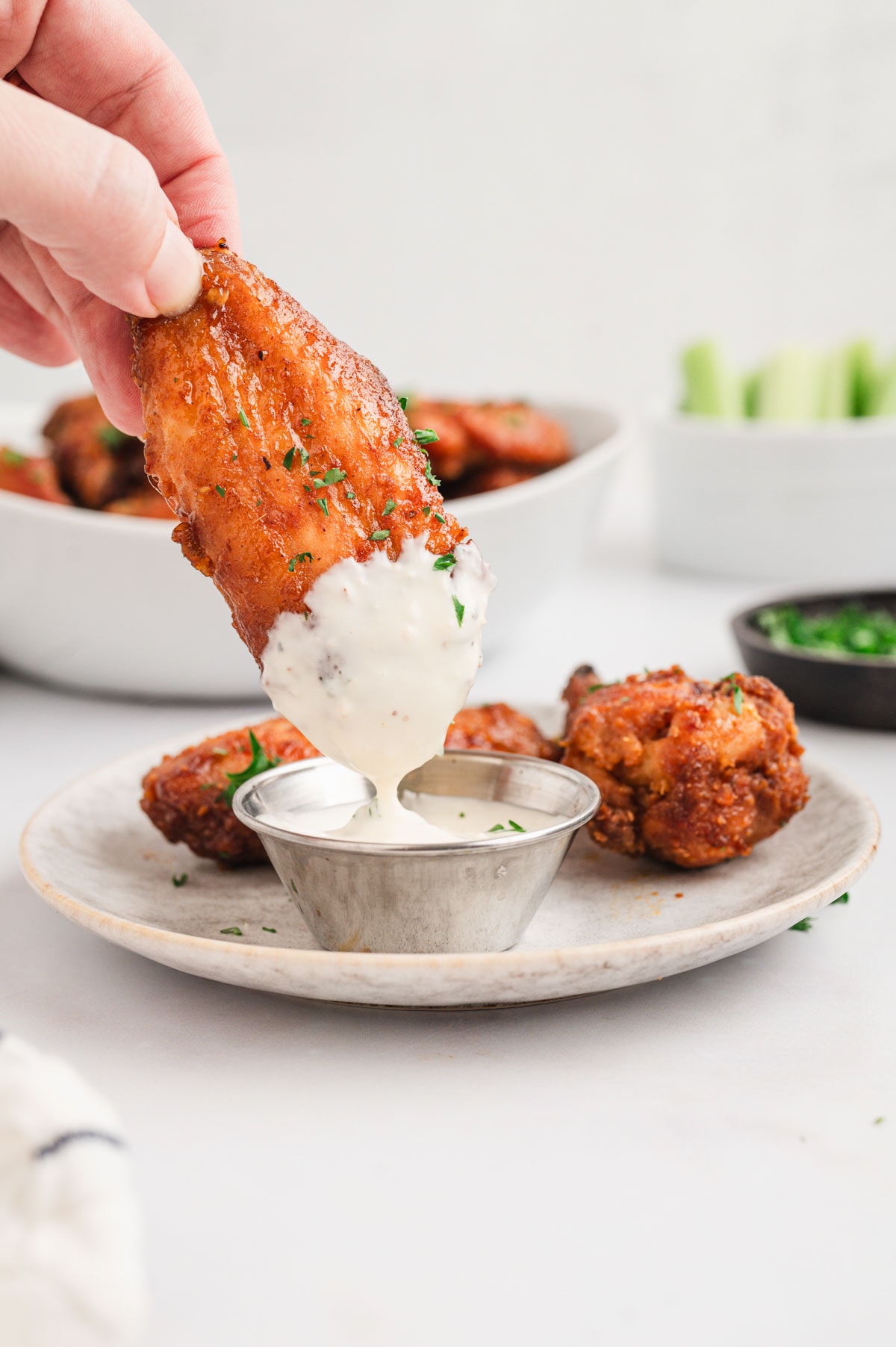 chicken wing dipped in ranch.