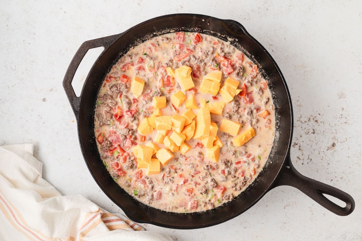 Tomatoes mixed with cream cheese and tomatoes and ground beef with cubes of velveeta.