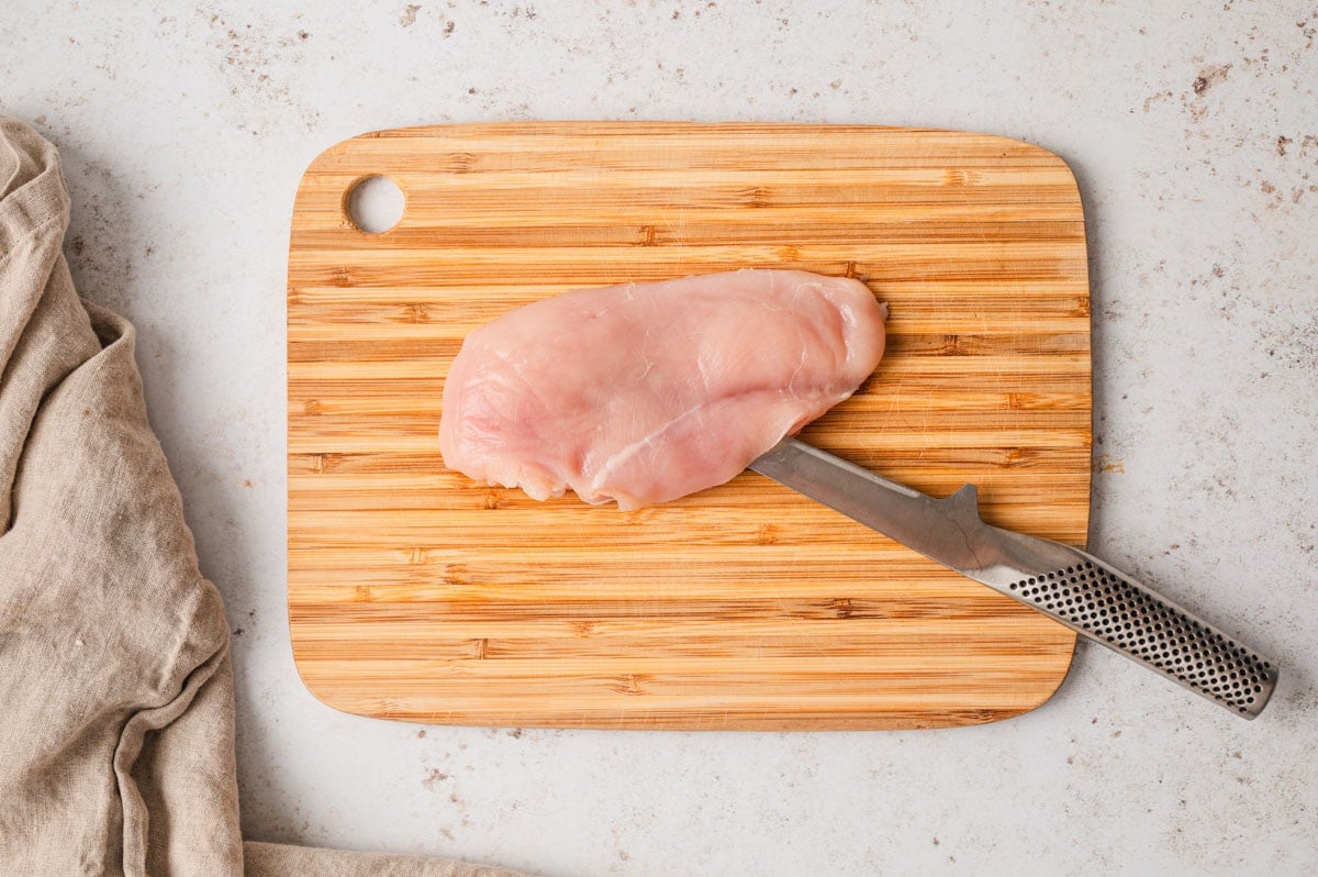 knife cutting into a chicken breast