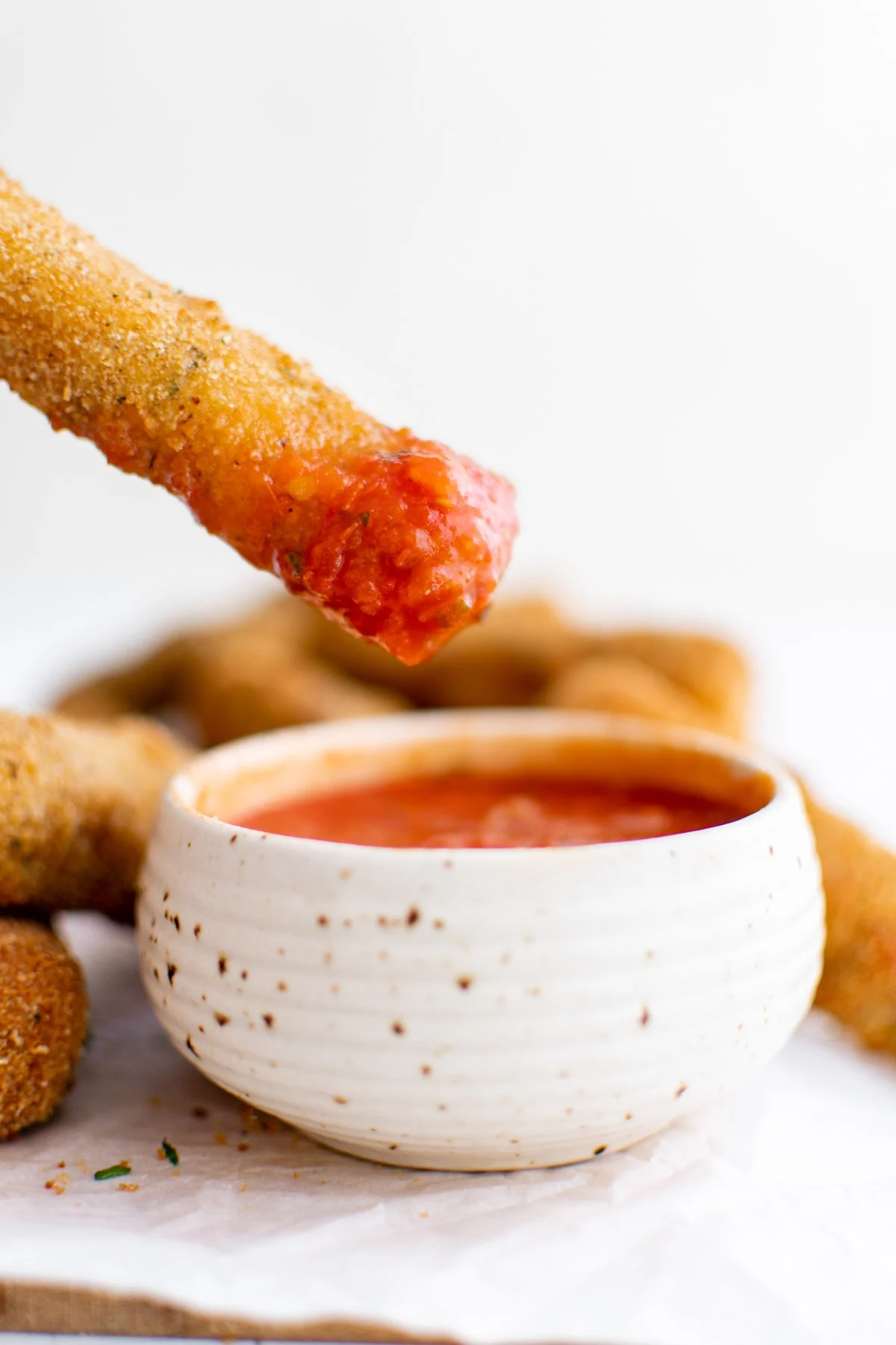 a mozzarella stick dipped in marinara