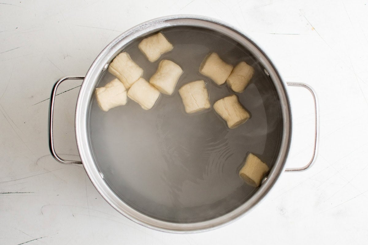 Pretzel bites dough in a baking soda bath.