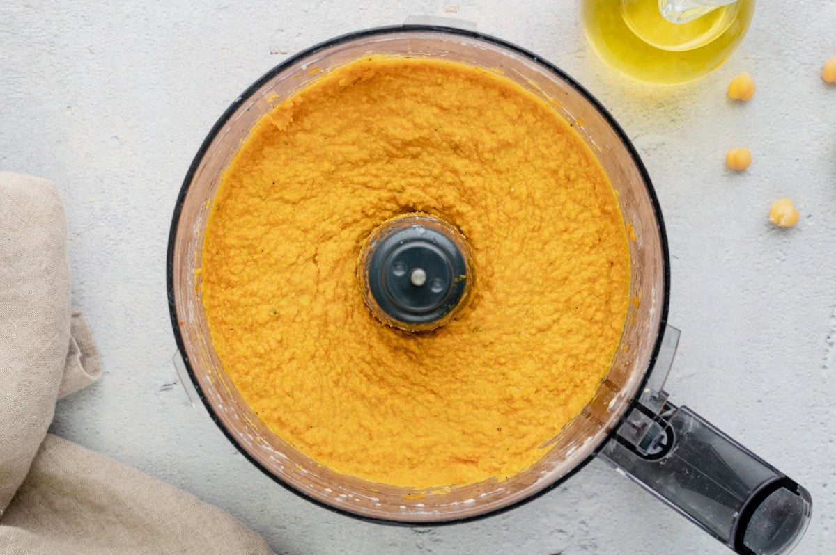 Smooth blended pumpkin hummus in a food processor.