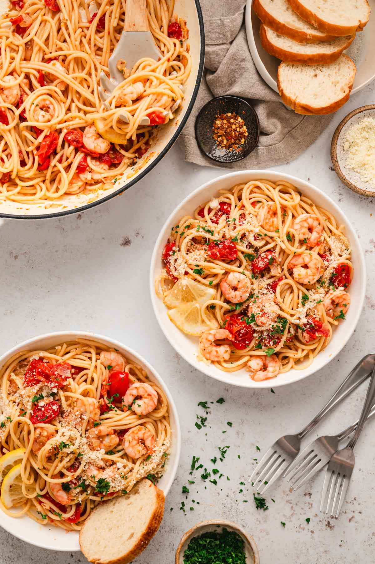 Shrimp and tomato pasta served in 2 plates.