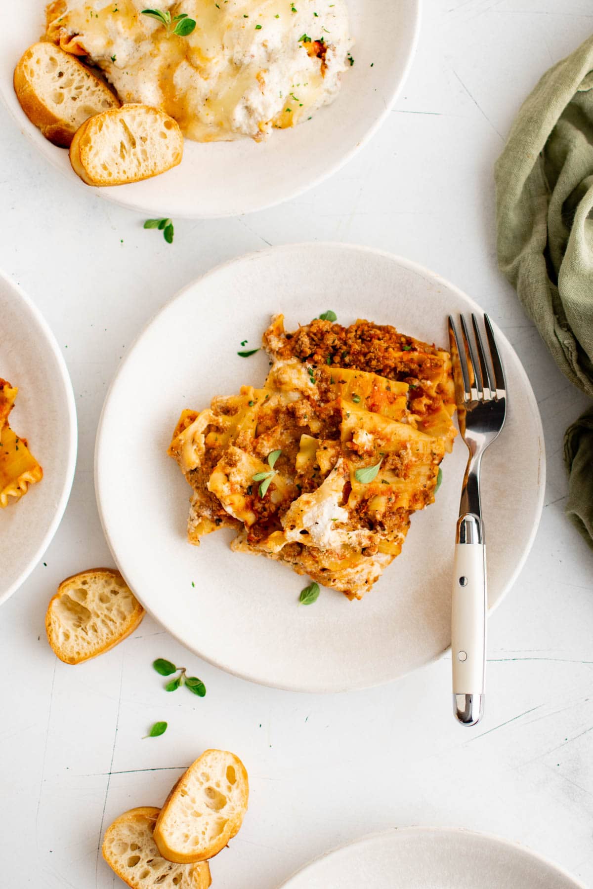 Serving of lasagna on a white plate.