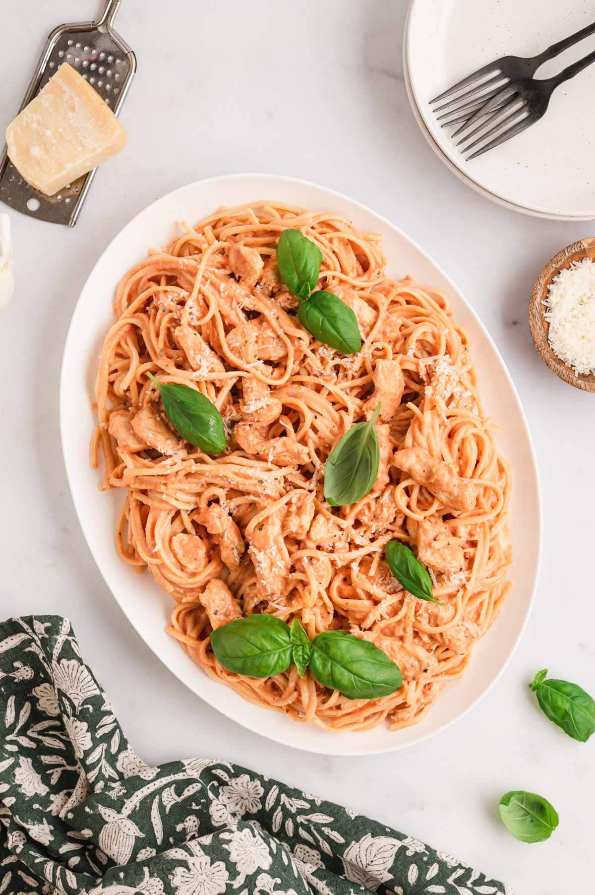 creamy chicken tomato pasta in a white serving dish