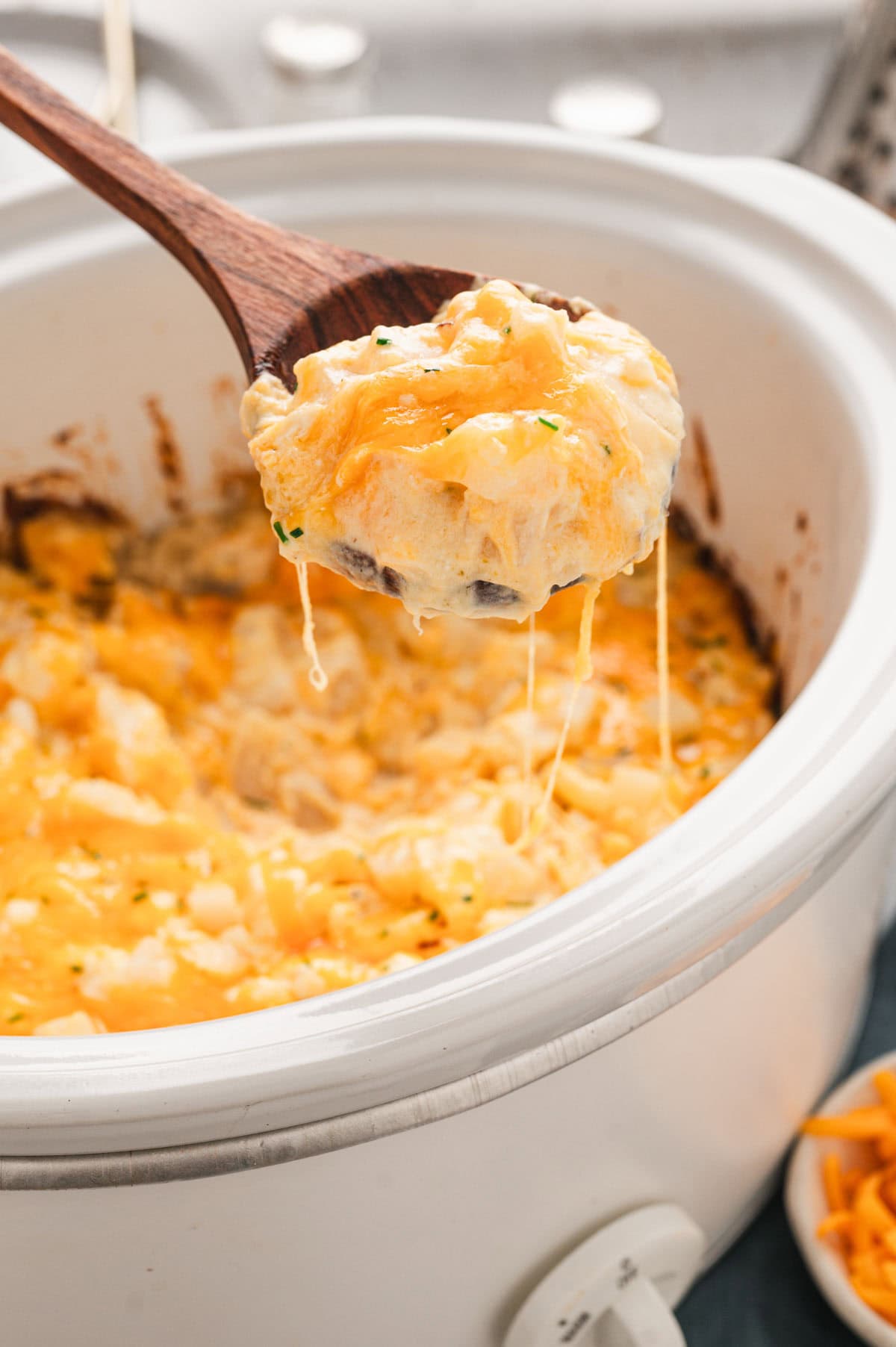 cheesy potatoes in a white crockpot