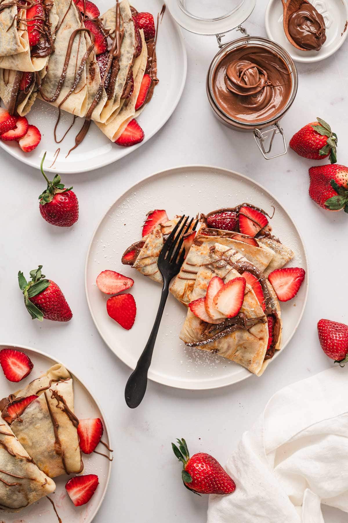 Nutella crepes on serving plates.