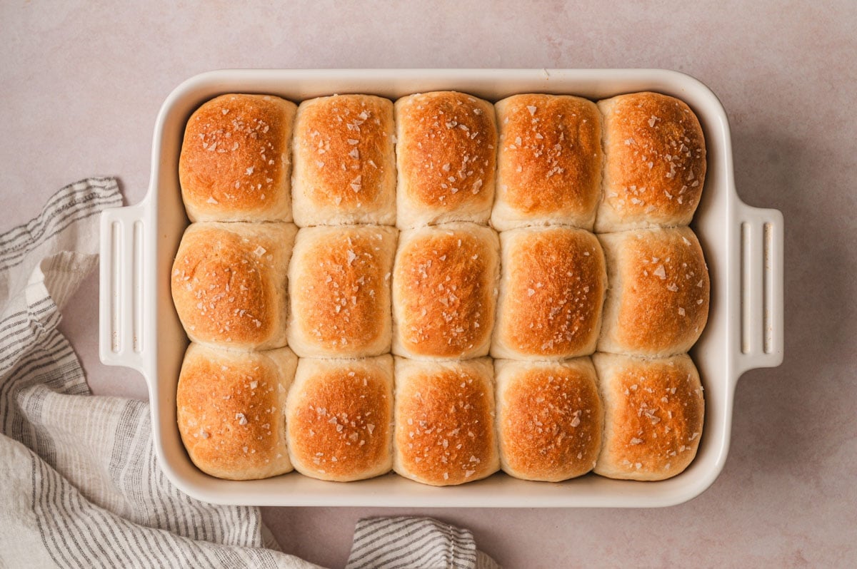 Dinner rolls with golden brown tops in a baking dish.