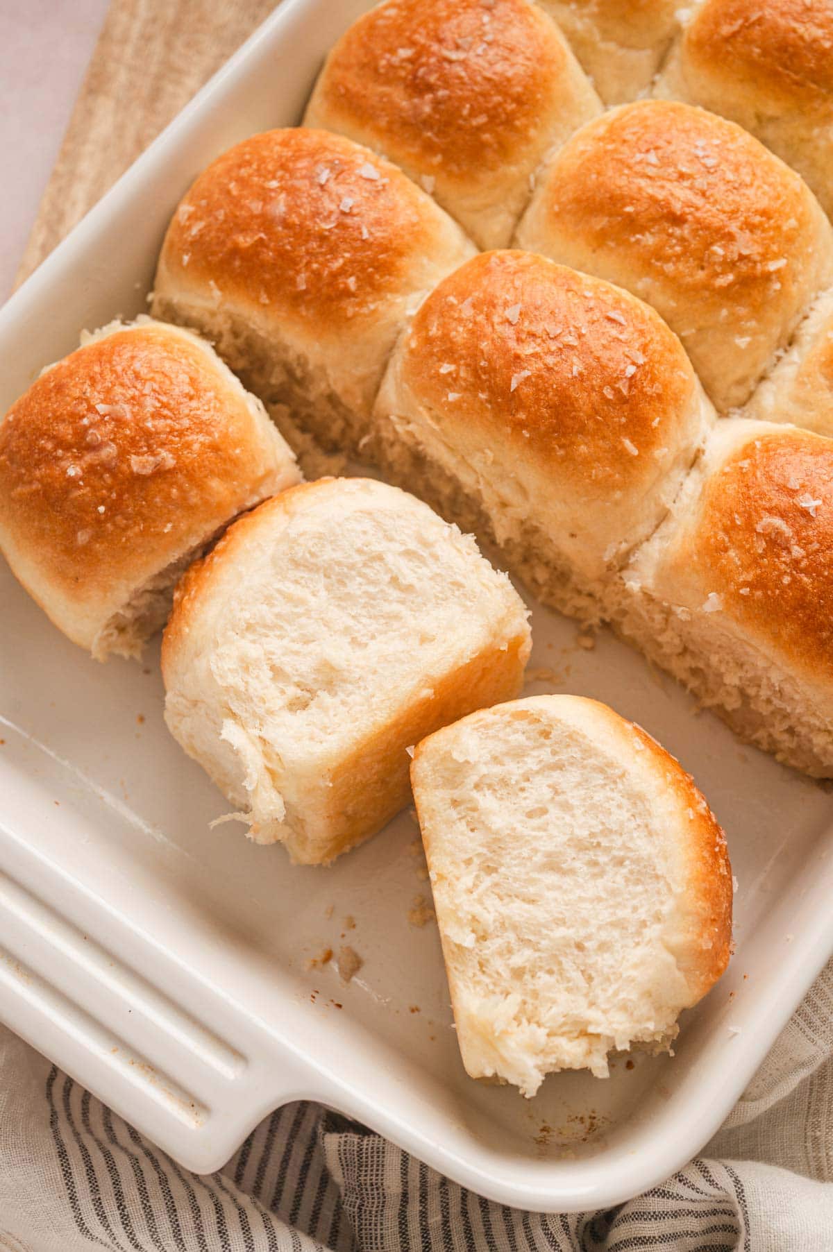 Dinner rolls in a white baking dish.