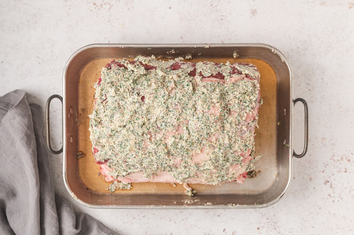 prime rib roast slathered with butter and dherbs