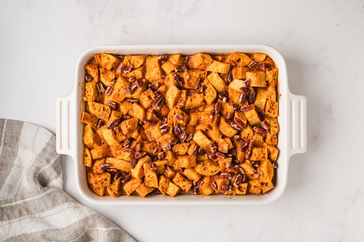 baked pumpkin bread pudding in a white baking dish