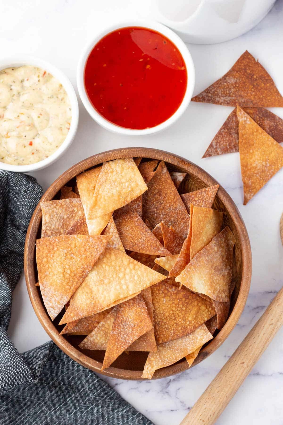 Bowl with wonton chips, small bowl of sweet and sour sauce.