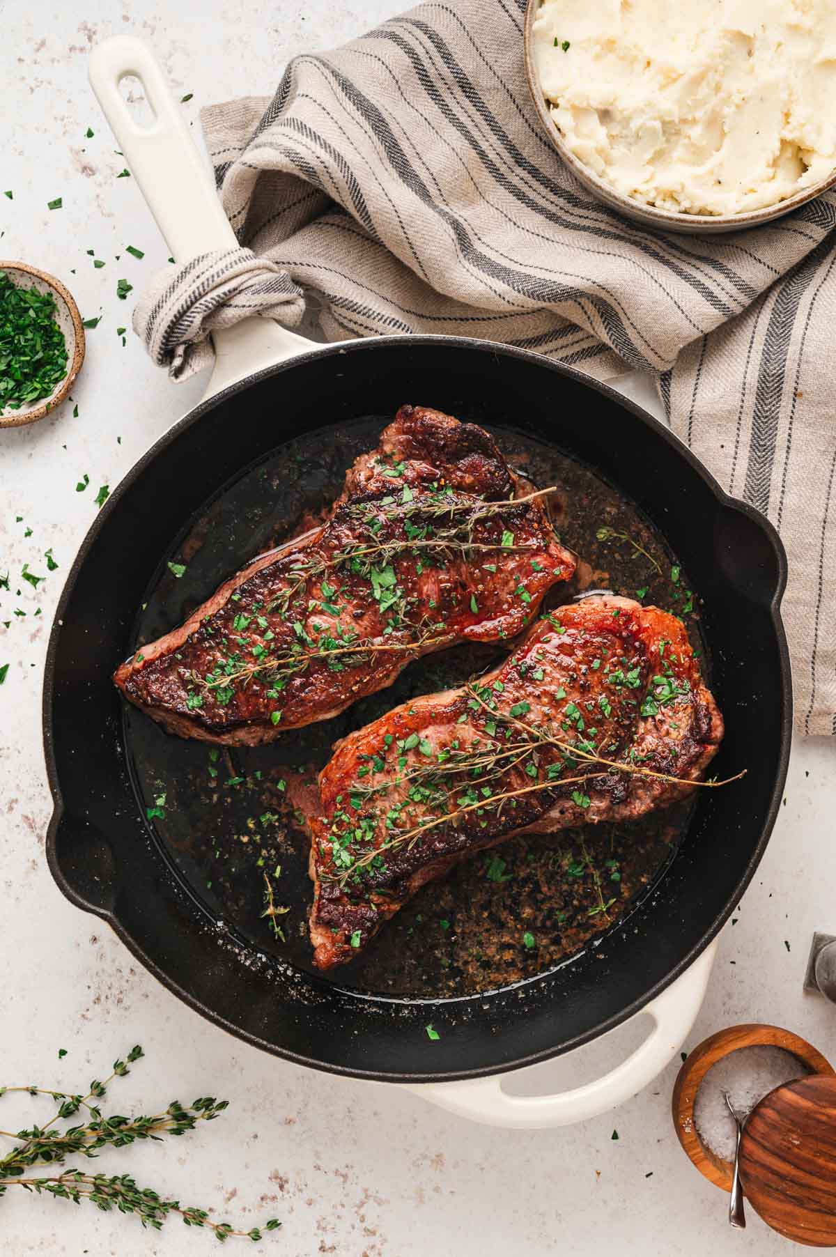 2 steaks in a cast iron pan