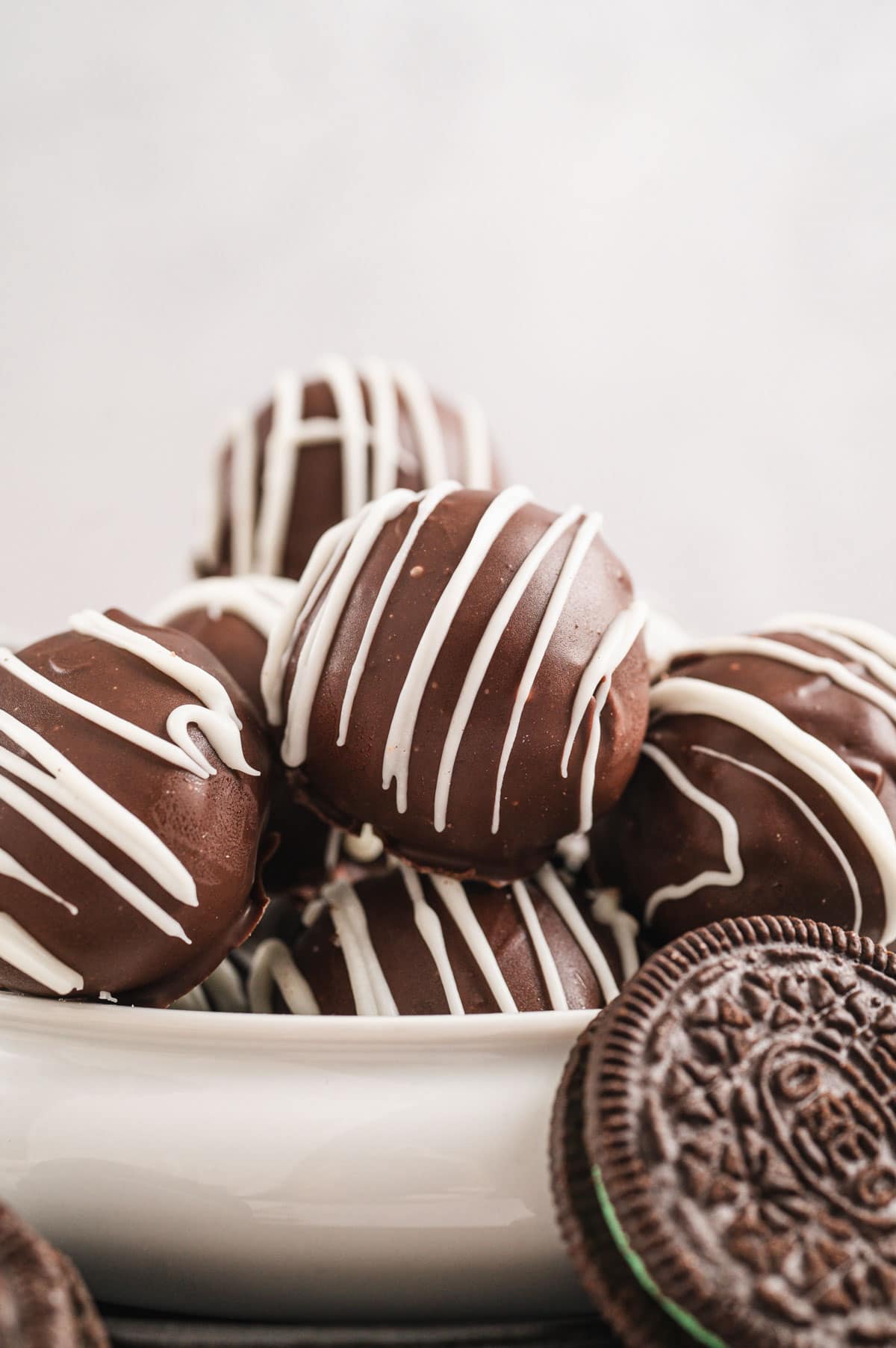 Oreo truffle balls stacked in a white bowl